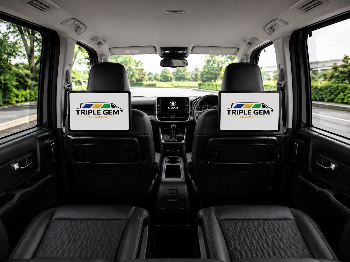 Dual seat-back passenger screens displaying Triple Gem Transit branding inside the van